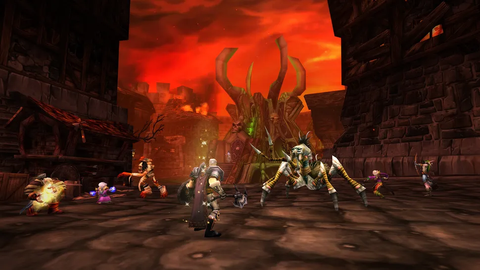 An image of 5 players fighting monsters in a broken down village